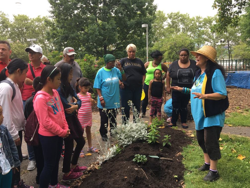 Bonnie Ora Sherk instructing the group before planting; Roosevelt Island Day, June 17, 2017 on Roosevelt Island, NYC