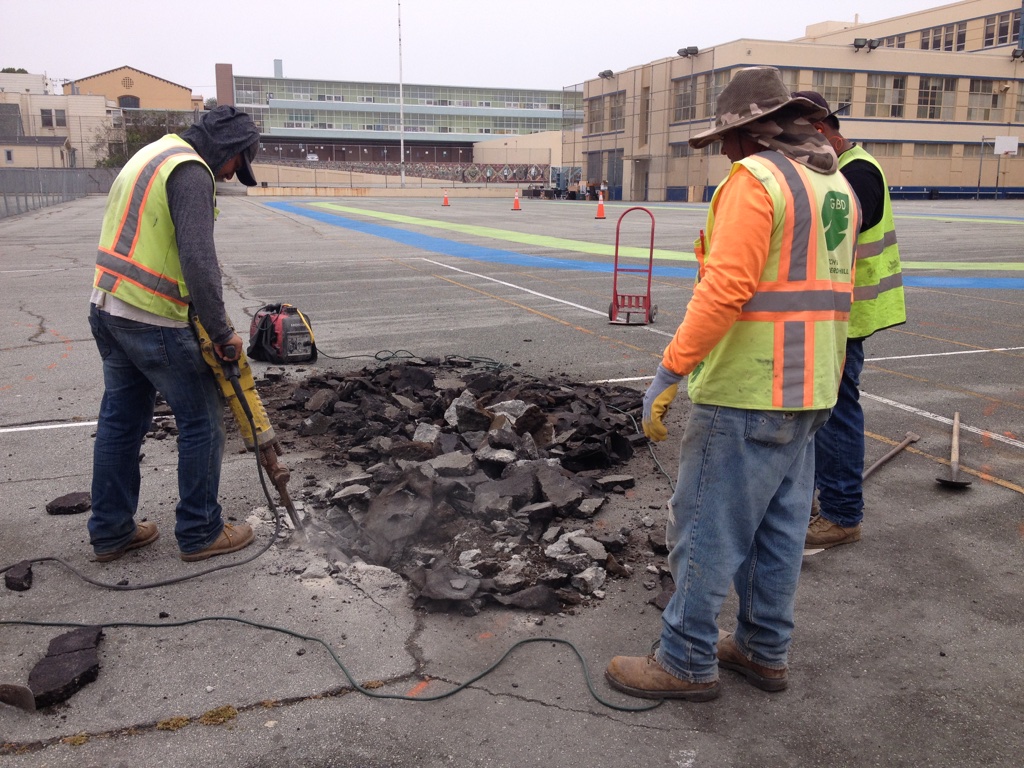 Digging up asphalt and concrete at the Rear Yard of James Denman Middle School