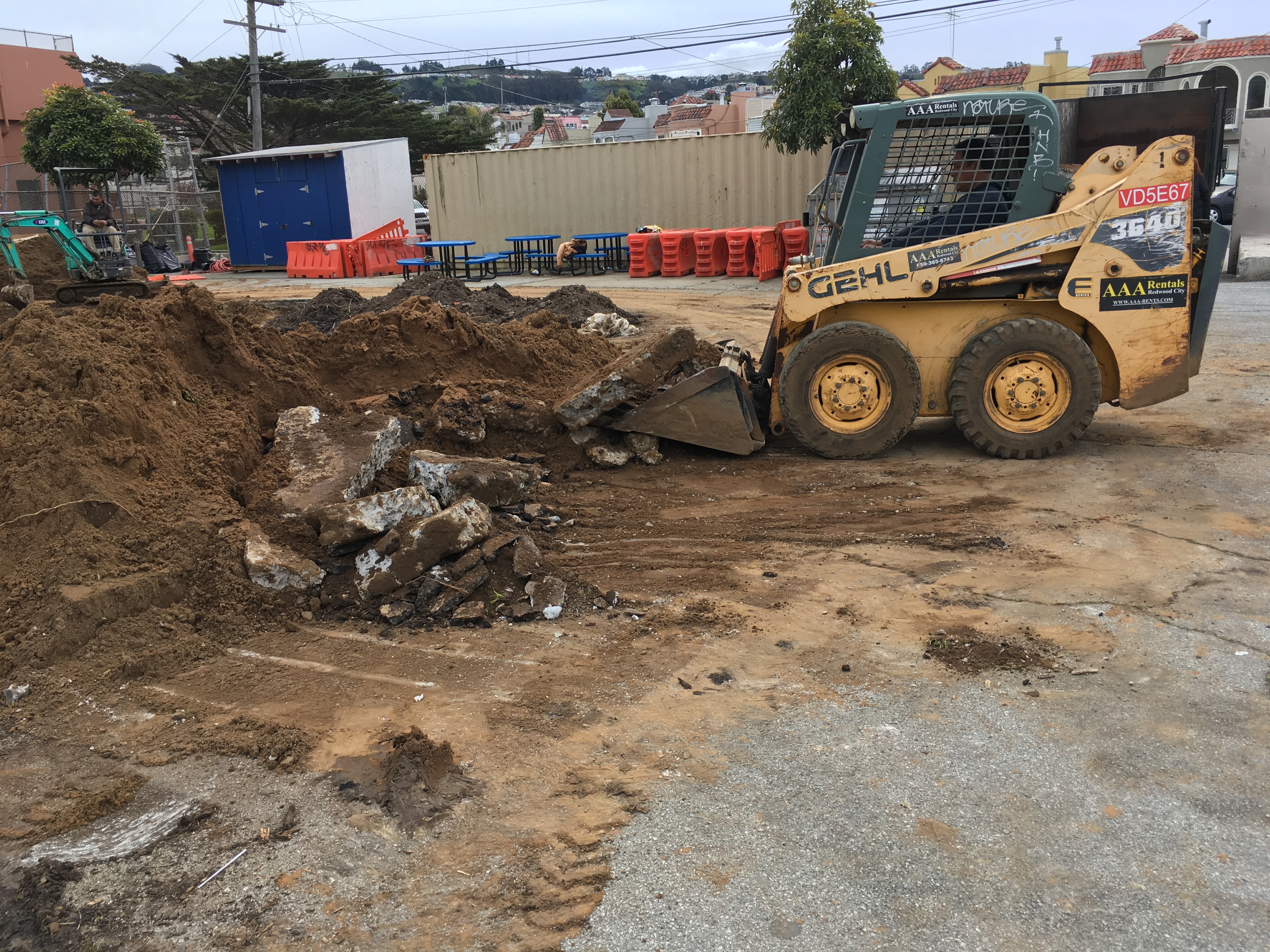 Catarino Mendoza and his crew digging out second layer of asphalt and concrete