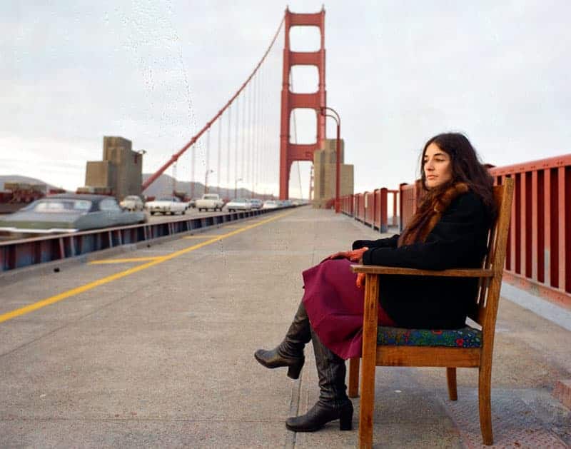 Bonnie Ora Sherk sitting on the Golden Gate Bridge